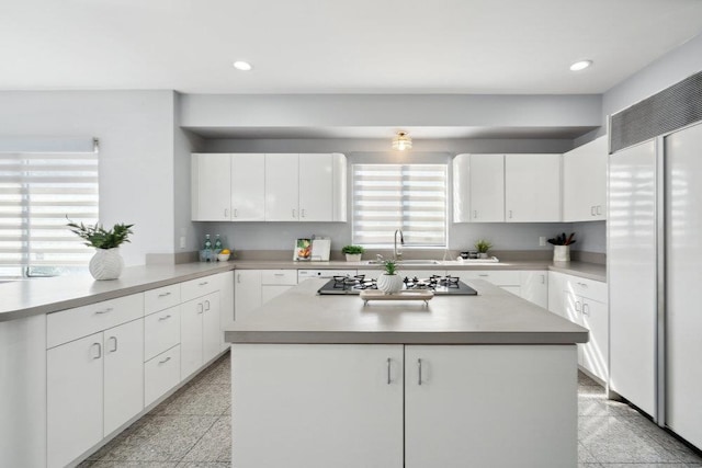 kitchen featuring white cabinetry, light countertops, and white built in refrigerator