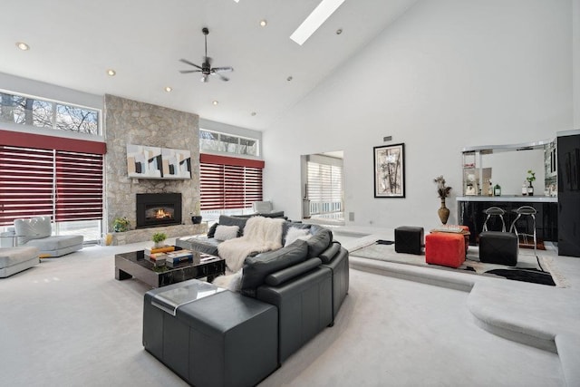 living area with carpet, a skylight, a fireplace, and a wealth of natural light