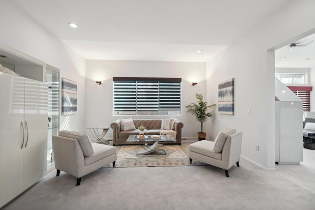 living room with recessed lighting, baseboards, and light colored carpet