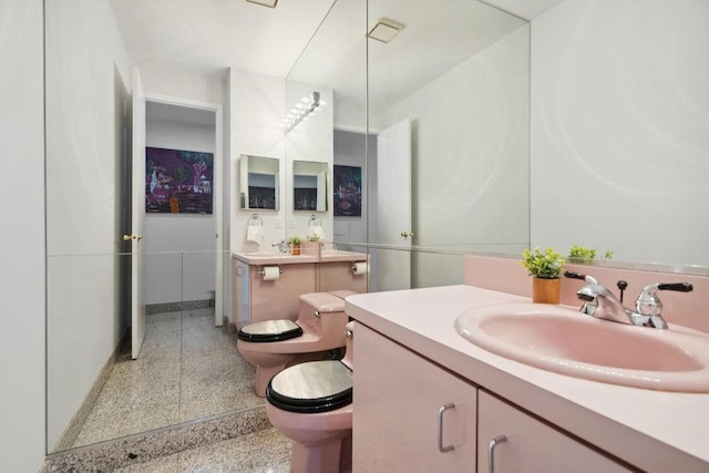 bathroom featuring a bidet, vanity, and toilet