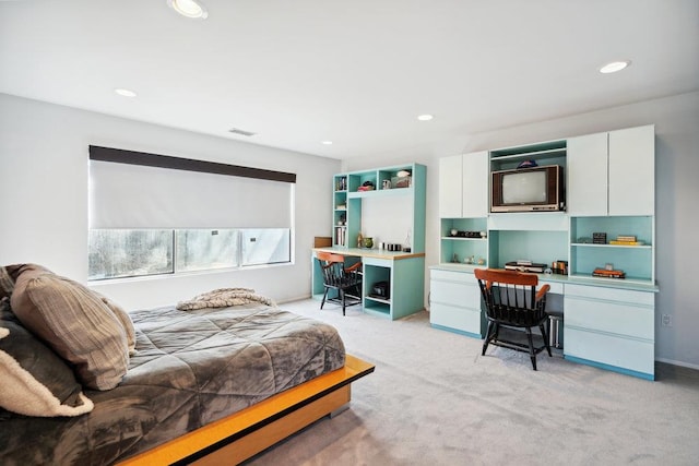 bedroom with light carpet, built in desk, visible vents, and recessed lighting