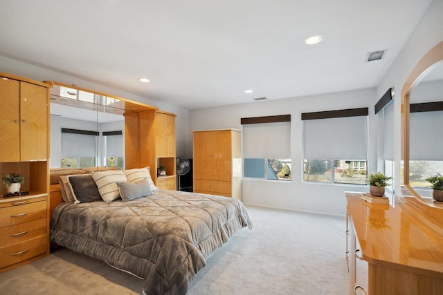 bedroom featuring recessed lighting, visible vents, and light carpet