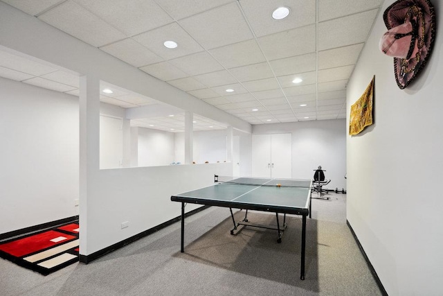 recreation room featuring a paneled ceiling, baseboards, and recessed lighting