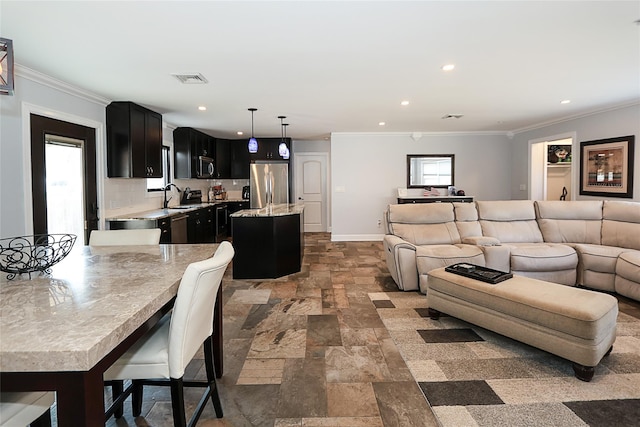 living room featuring visible vents, ornamental molding, and stone tile flooring