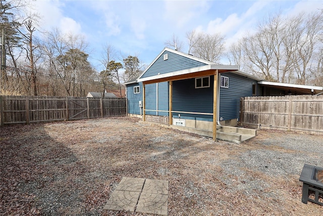 back of property with a fenced backyard