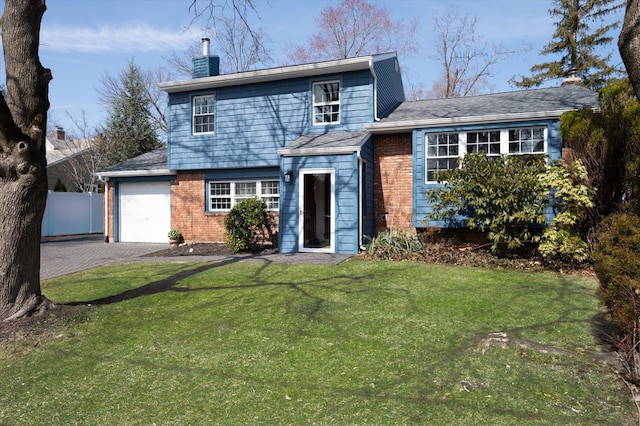 view of front facade with fence, a front yard, a chimney, a garage, and driveway