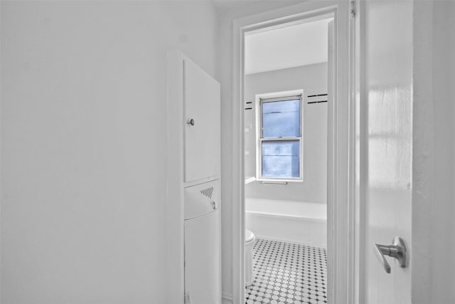 full bathroom with toilet and tile patterned floors