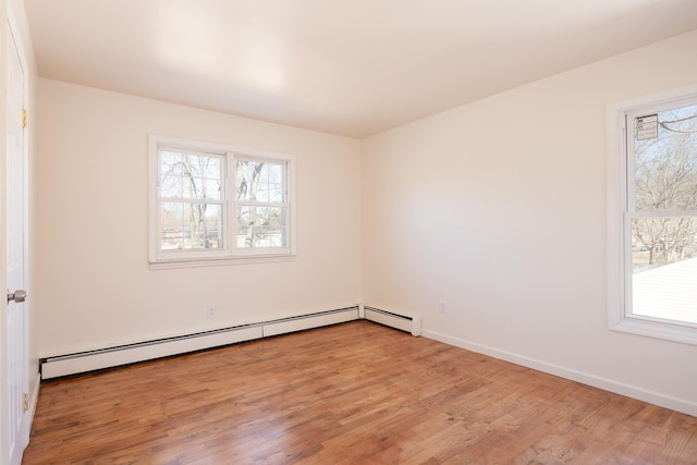 unfurnished room featuring baseboards, a wealth of natural light, and light wood-style floors