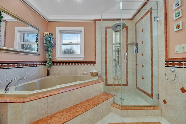 bathroom with a stall shower, ornamental molding, and a garden tub