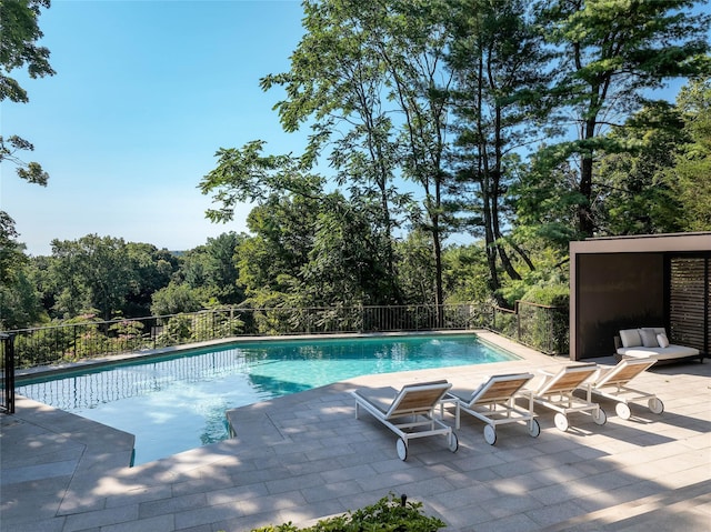 view of swimming pool featuring a patio, a fenced in pool, and fence