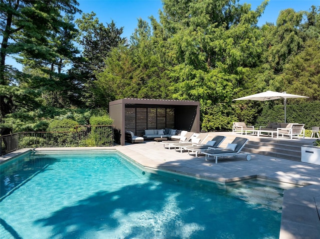 view of swimming pool featuring an outdoor living space, a patio area, and a fenced in pool