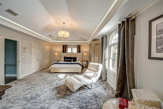 bedroom with visible vents, a raised ceiling, carpet, crown molding, and a notable chandelier