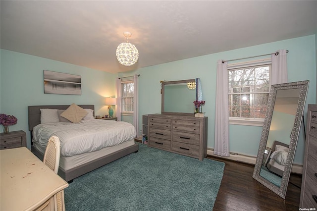 bedroom featuring a chandelier and dark wood-style flooring