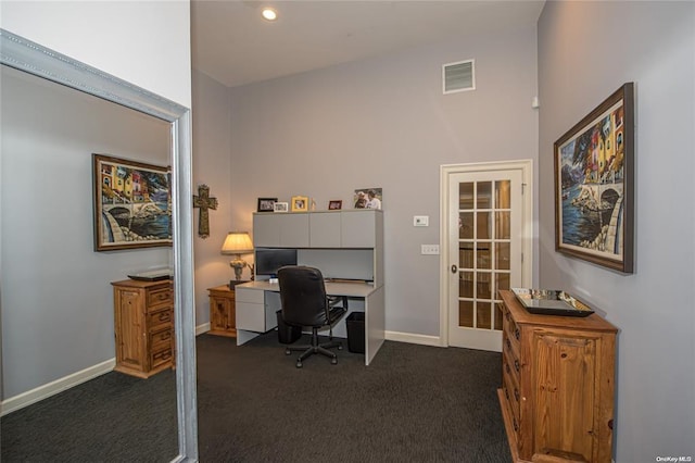 office space featuring dark colored carpet, french doors, visible vents, and baseboards