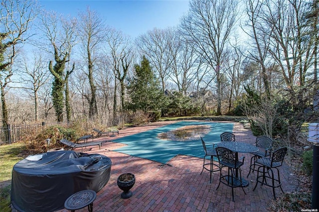 view of pool featuring a patio area, fence, grilling area, and a fenced in pool