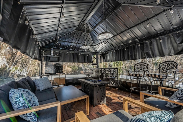 wooden terrace featuring a gazebo and an outdoor living space with a fire pit