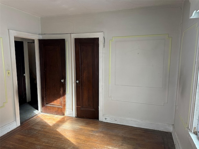 unfurnished bedroom with wood finished floors