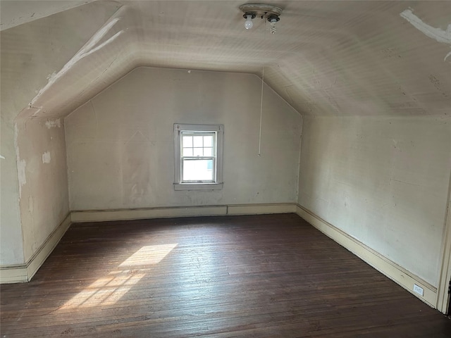 additional living space with lofted ceiling and dark wood finished floors