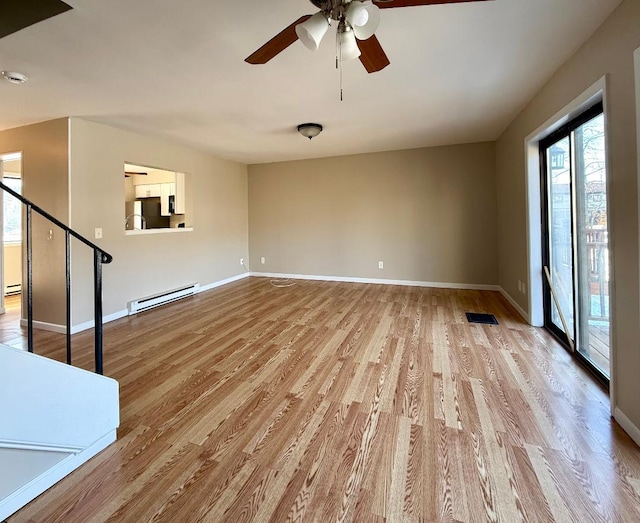 unfurnished living room featuring visible vents, a baseboard heating unit, a ceiling fan, light wood-type flooring, and baseboards