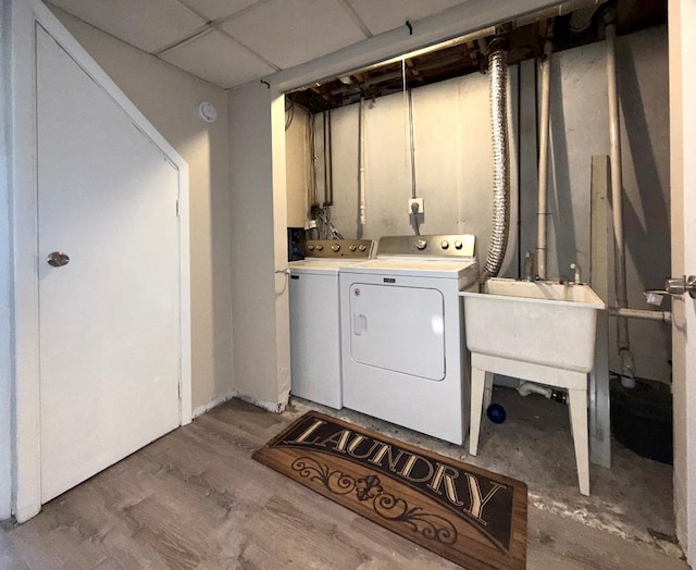 laundry area featuring laundry area, independent washer and dryer, and wood finished floors