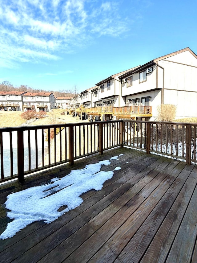 wooden deck featuring a residential view and a water view