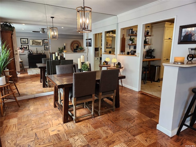 dining space featuring ceiling fan with notable chandelier, ornamental molding, and baseboards