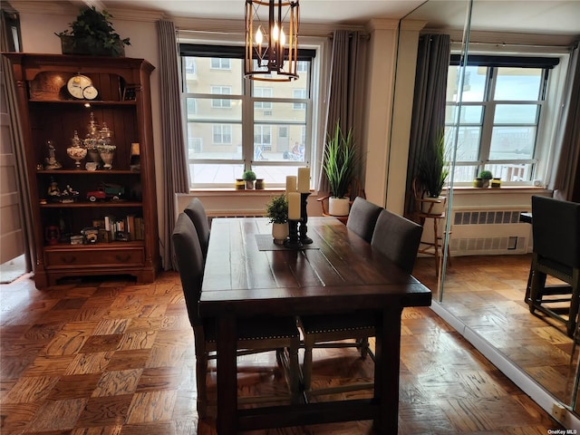 dining room with radiator and a notable chandelier