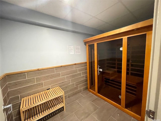 view of sauna featuring tile patterned flooring and wainscoting