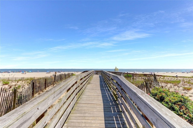 surrounding community featuring a beach view and a water view