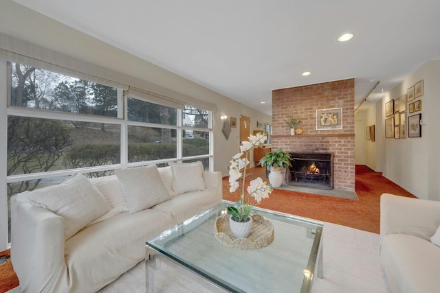 living room with recessed lighting and a fireplace