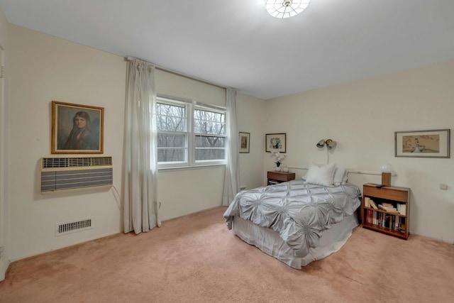 bedroom with visible vents, carpet flooring, and a wall mounted AC