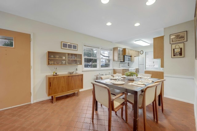 dining space with recessed lighting and baseboards