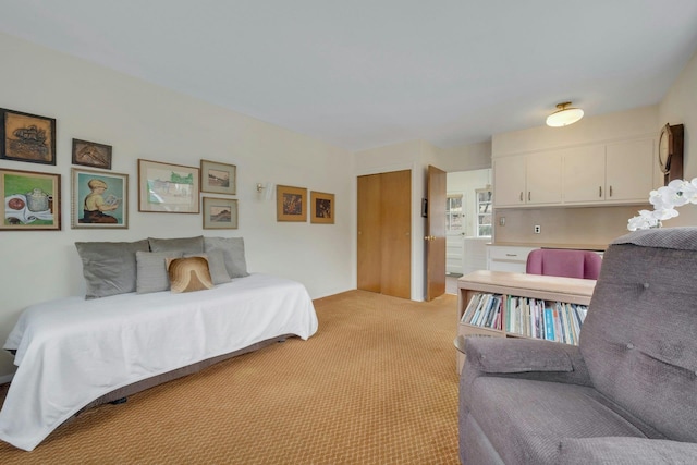 bedroom with a closet and light carpet