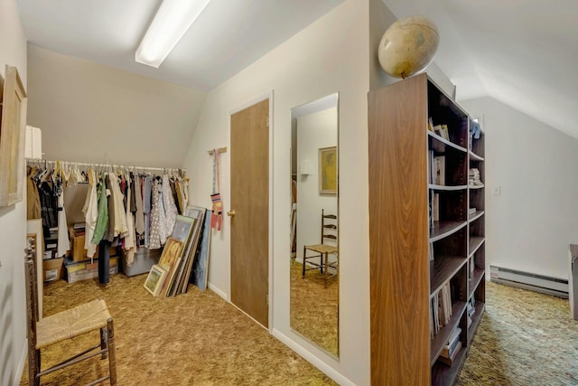 spacious closet featuring carpet floors, a baseboard radiator, and vaulted ceiling