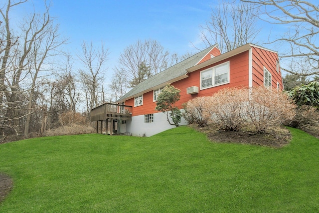 back of property featuring a wall mounted AC, a lawn, and a wooden deck