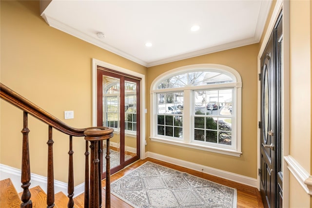 entrance foyer featuring recessed lighting, baseboards, light wood-style floors, and ornamental molding