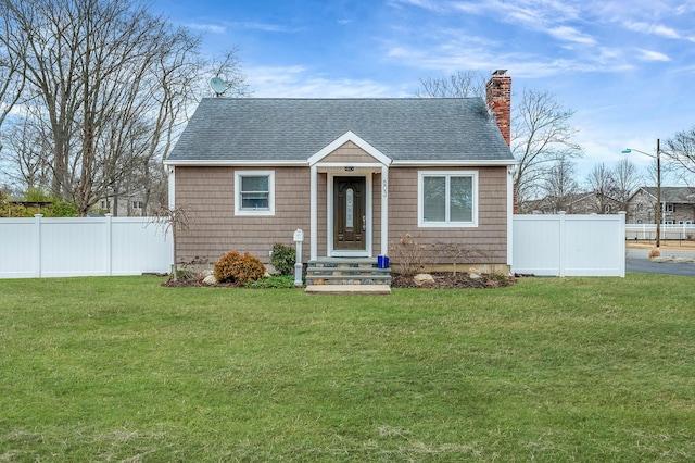 bungalow featuring a front lawn, a chimney, and fence