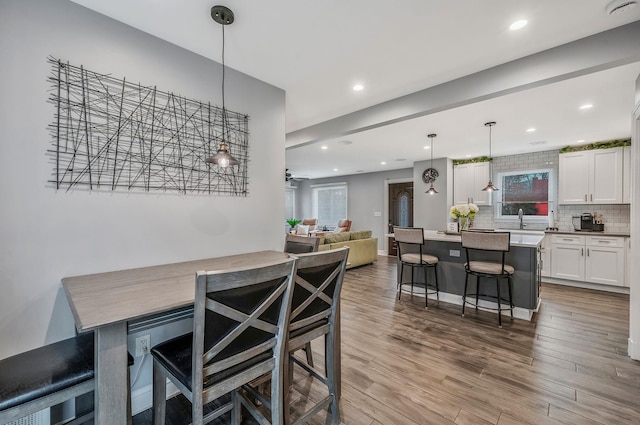 dining area with recessed lighting and wood finished floors