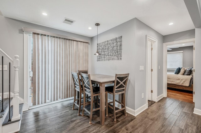 dining area with baseboards, stairway, wood finished floors, and recessed lighting