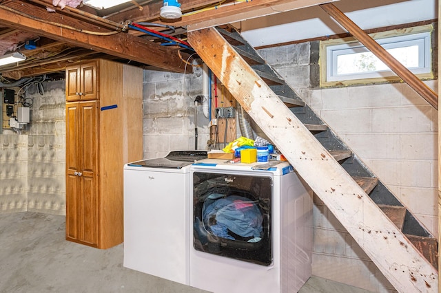 basement with stairway and washer and clothes dryer