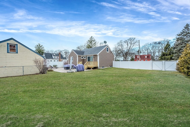 view of yard featuring a fenced backyard and a gate