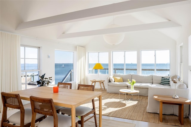 sunroom featuring a water view and lofted ceiling with beams