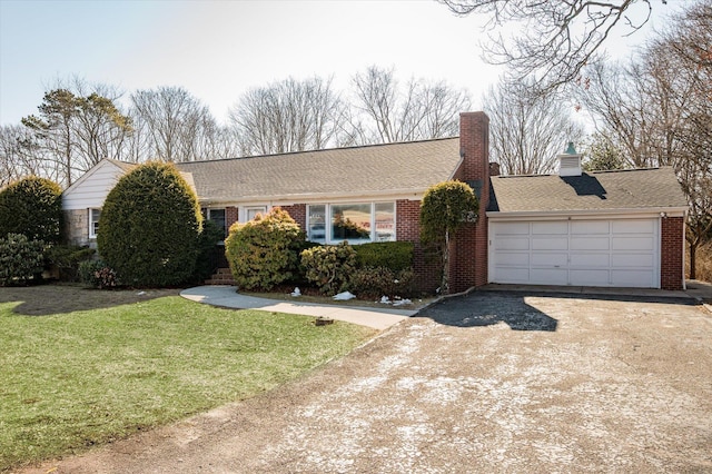 ranch-style home with driveway, a garage, brick siding, a chimney, and a front yard