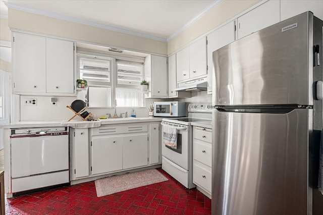 kitchen featuring brick floor, ornamental molding, a sink, white appliances, and under cabinet range hood