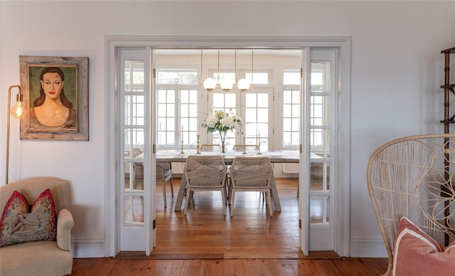 dining area with a chandelier and light wood-style floors