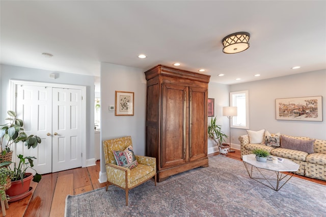 living room featuring light wood-type flooring, baseboards, and recessed lighting