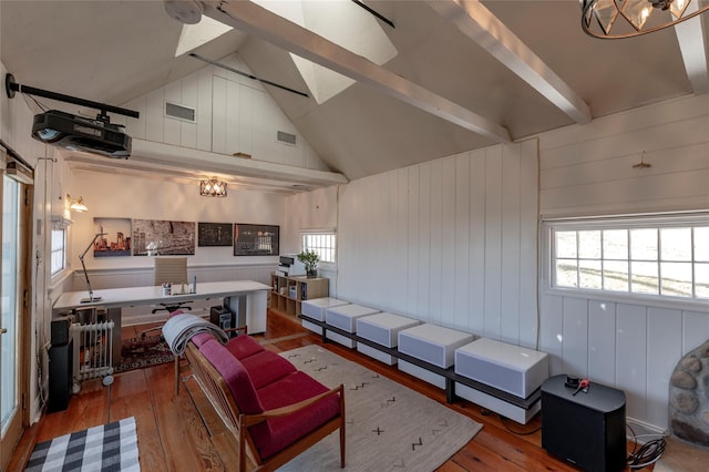 living room featuring high vaulted ceiling, hardwood / wood-style flooring, visible vents, and beam ceiling