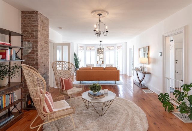 71 Old Mountain Rd S, Nyack, NY 10960 - living room featuring a chandelier, wood-type flooring, and baseboards