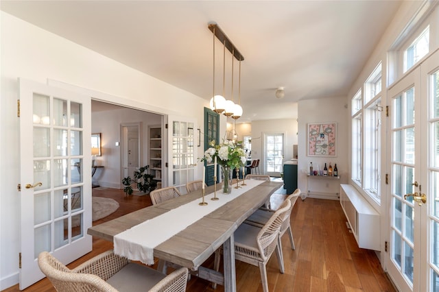 71 Old Mountain Rd S, Nyack, NY 10960 - dining space featuring french doors, wood finished floors, baseboards, and a chandelier