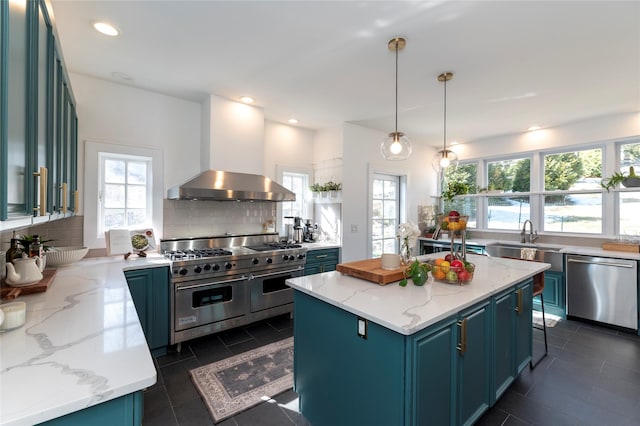 71 Old Mountain Rd S, Nyack, NY 10960 - kitchen featuring appliances with stainless steel finishes, a sink, wall chimney range hood, decorative backsplash, and a center island
